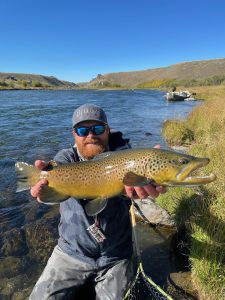 Guide Jarrett Voiles with fine Madison River brown trout that guest Richard caught